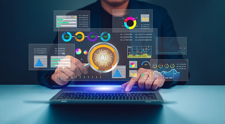 Photograph of a businessman sitting at desk with a laptop on it holding a magnifying glass that has the letters AI in the center of it.