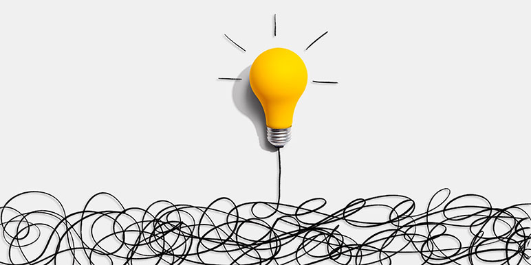 Drawing of a yellow light bulb with lines radiating from it sitting above a bunch of squiggly lines it is plugged into.